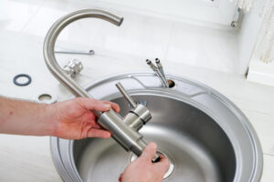 Installing a new kitchen sink faucet fixture - kitchen installation services