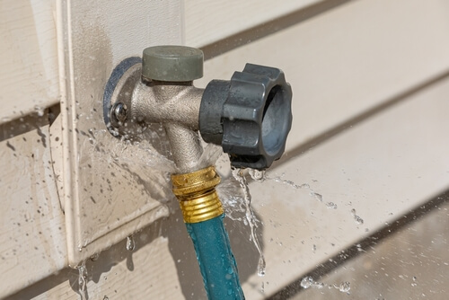 broken hose spigot spraying water