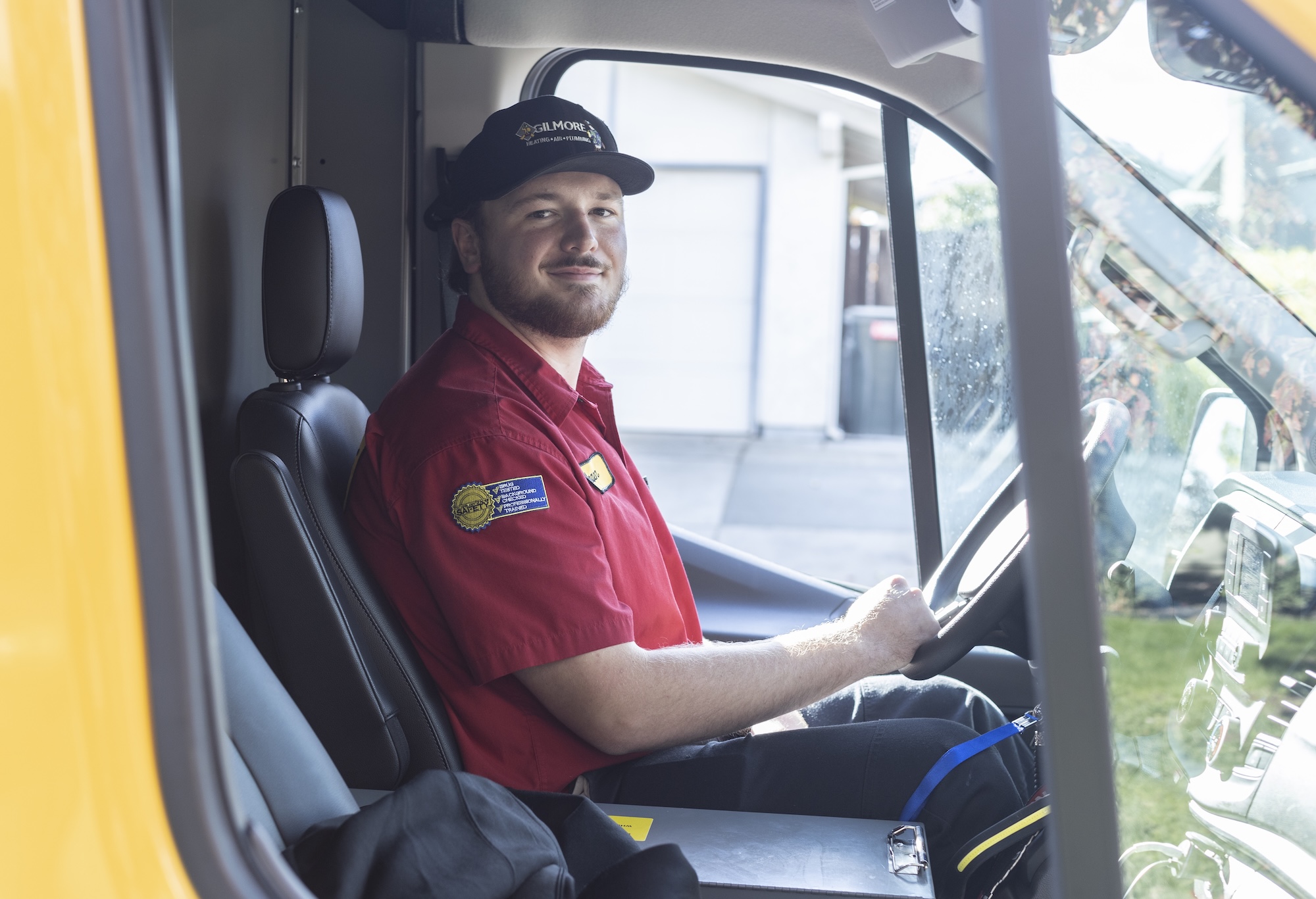 technician sitting in driver's seat of truck