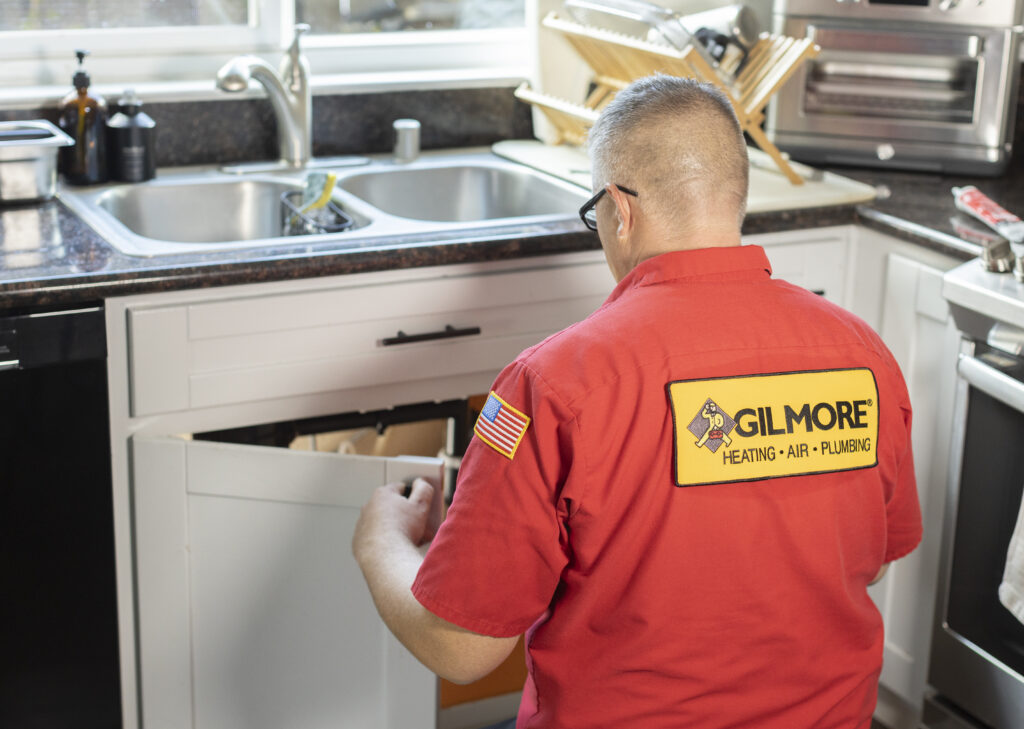 plumber-checking-under-sink-for-water-leak