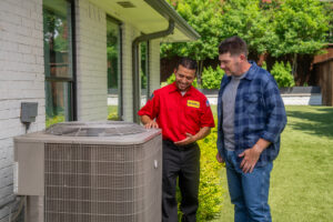ac technician and homeowner near hvac system